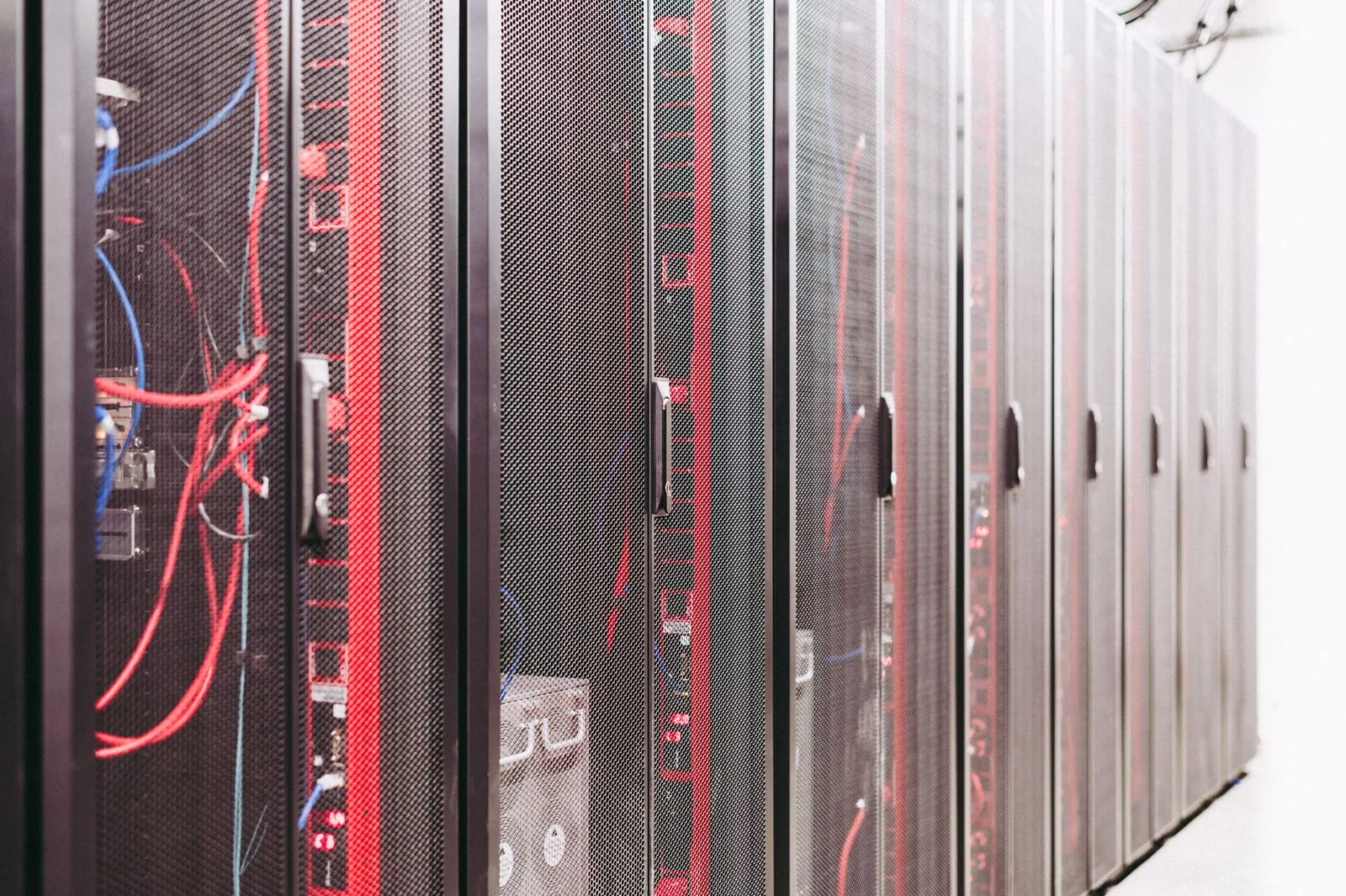 Rows of server racks and organized cabling inside a data center